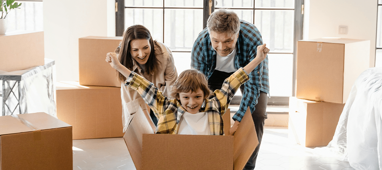 family with moving boxes playing